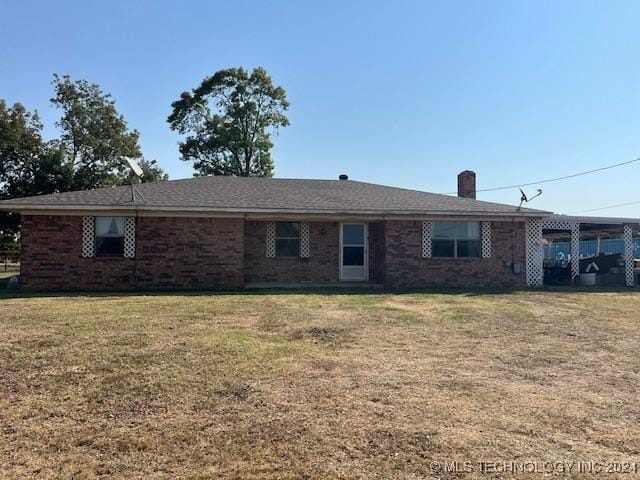 1384 Academy Rd, Bennington, OK 74723 - single story home with a chimney, a front yard, and a carport