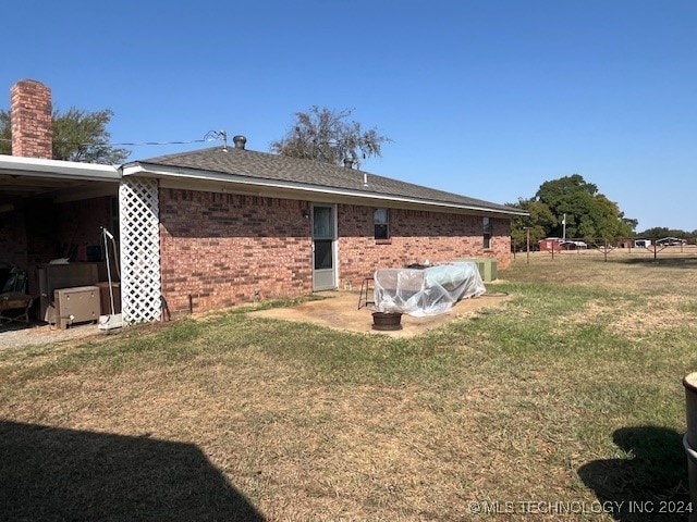 back of house with a lawn