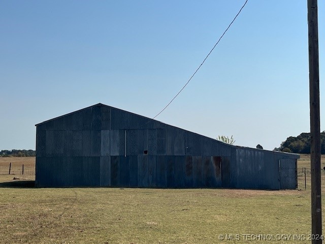 exterior space with an outdoor structure and a lawn