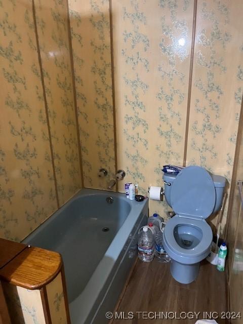 1384 Academy Rd, Bennington, OK 74723 - full bathroom with a bath, wallpapered walls, toilet, and wood finished floors