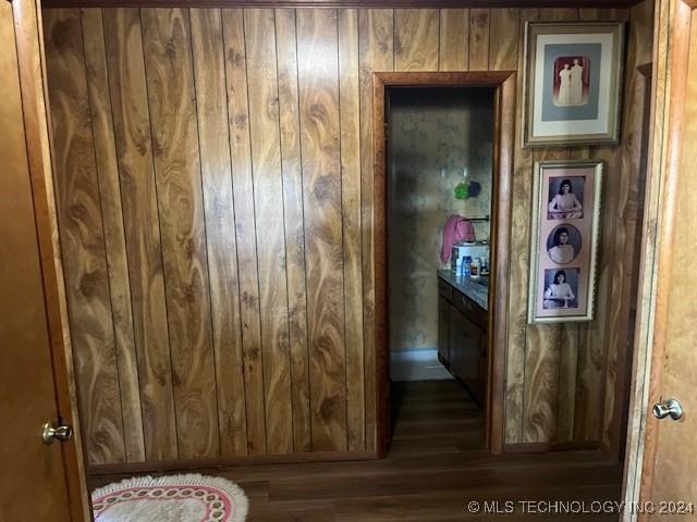 1384 Academy Rd, Bennington, OK 74723 - hallway with wood finished floors and wood walls