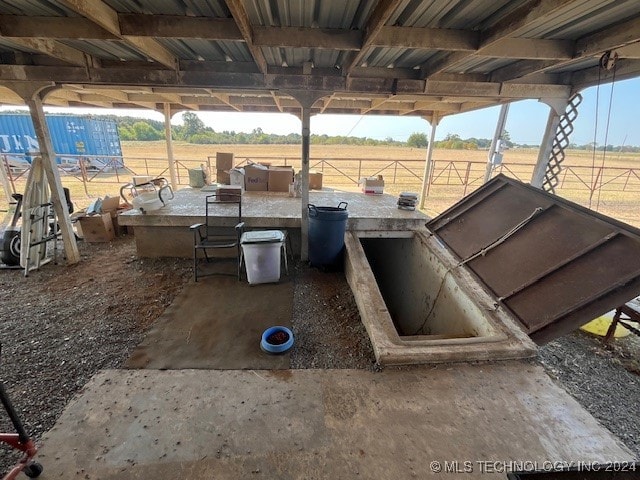 view of storm shelter with a rural view