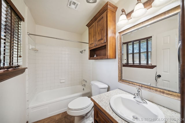 bathroom with toilet, vanity, and shower / tub combination