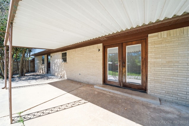 view of patio featuring french doors and fence