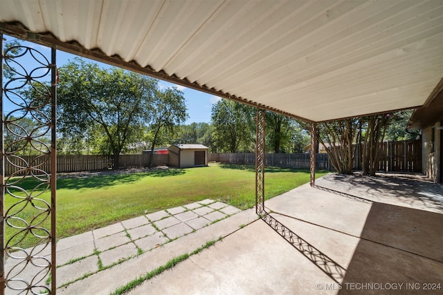 view of patio / terrace featuring a storage unit and an outbuilding