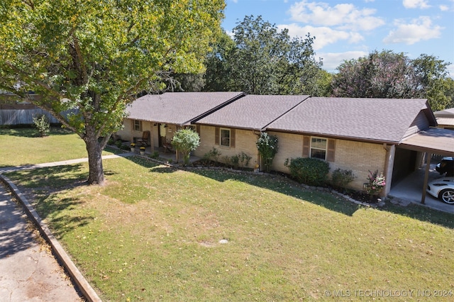 ranch-style house with brick siding, an attached carport, and a shingled roof