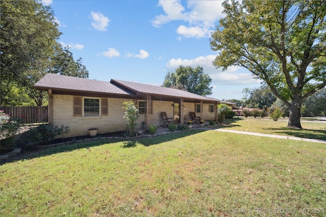 ranch-style house with brick siding and a patio area