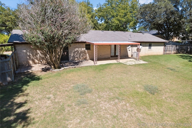 rear view of property featuring brick siding and a patio