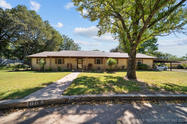 ranch-style home featuring a porch and brick siding