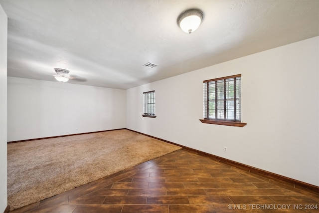 empty room with baseboards and wood finished floors