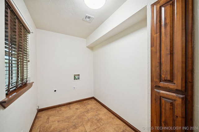 laundry room featuring hookup for an electric dryer, washer hookup, and baseboards