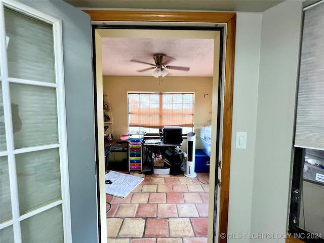 home office featuring ceiling fan and a textured ceiling