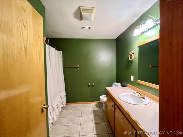 bathroom with a shower with shower curtain, tile patterned flooring, vanity, and toilet