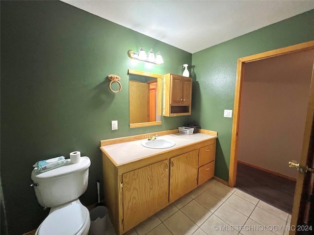 bathroom featuring vanity, toilet, and tile patterned floors