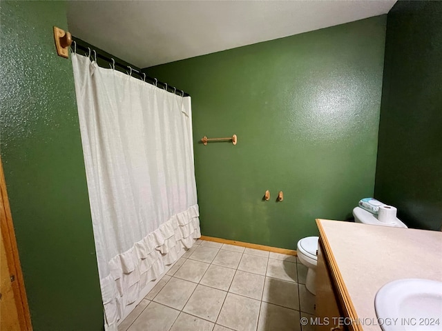 bathroom featuring vanity, walk in shower, tile patterned floors, and toilet