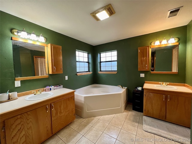 bathroom featuring vanity, tile patterned flooring, and a washtub