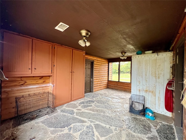 interior space with ceiling fan