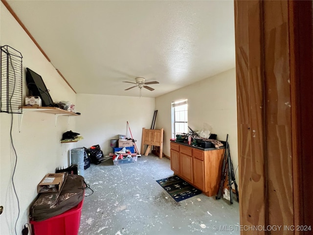 misc room with ceiling fan and a textured ceiling