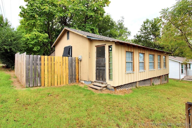 view of home's exterior with a yard