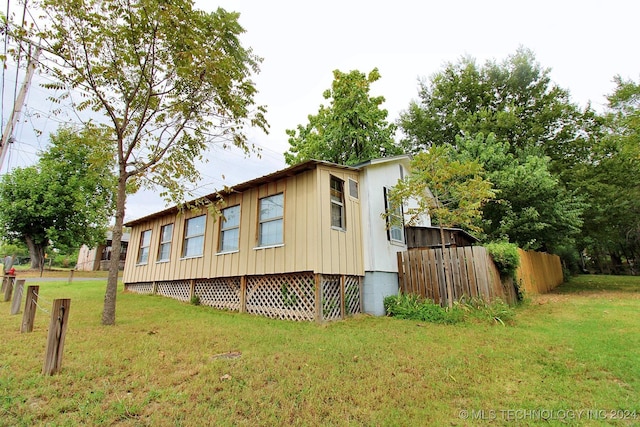 view of home's exterior with a yard