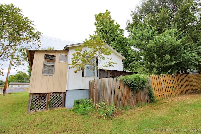 view of side of home featuring a yard