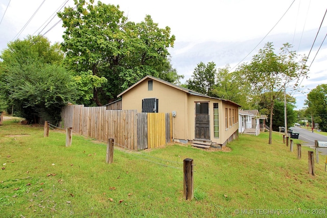 view of property exterior with a lawn