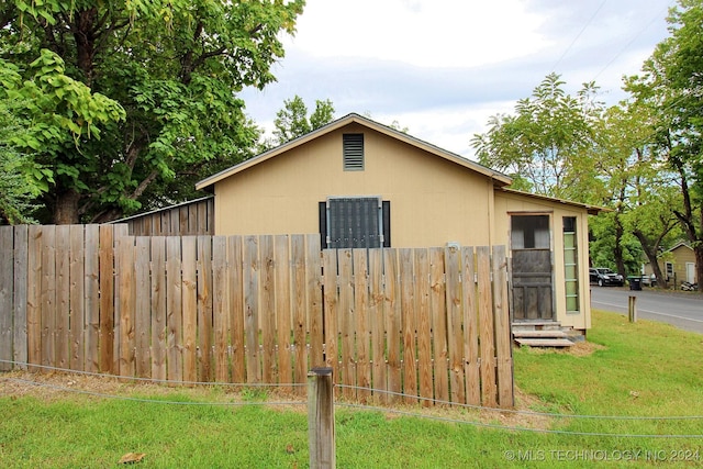 view of side of home featuring a yard