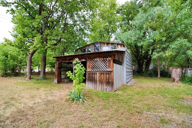 view of outbuilding featuring a yard