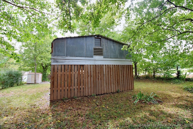 view of outbuilding featuring a lawn