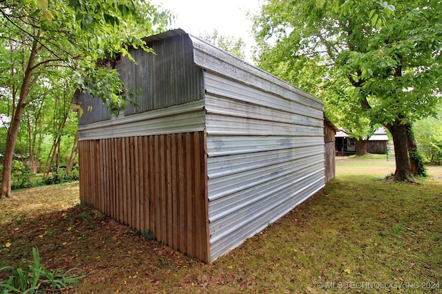 view of outbuilding with a lawn