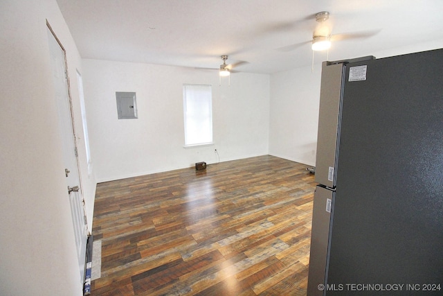 empty room featuring electric panel, ceiling fan, and dark hardwood / wood-style floors