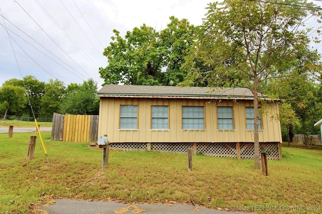 view of home's exterior with a yard