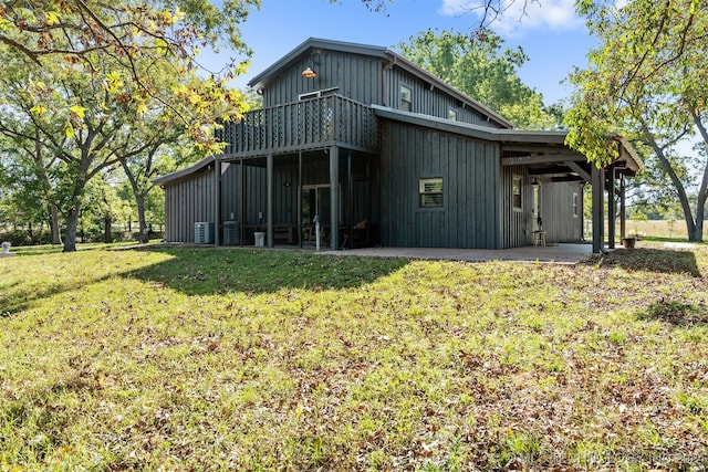 back of house with a lawn, central AC, and a patio area