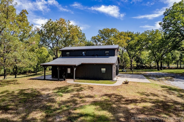 rear view of house with a lawn