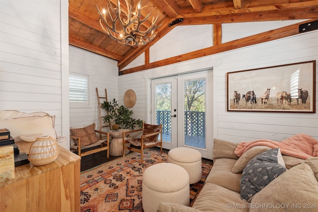 living room featuring lofted ceiling with beams, wooden ceiling, wood-type flooring, an inviting chandelier, and wooden walls