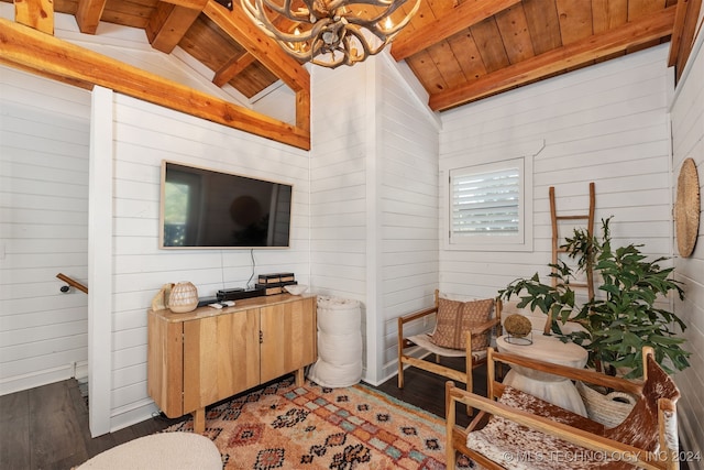 living room with vaulted ceiling with beams, wood walls, and dark wood-type flooring