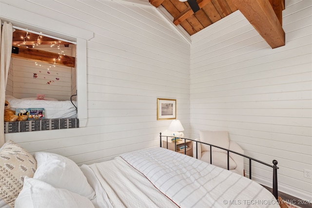 bedroom featuring wooden walls, wood ceiling, and lofted ceiling with beams