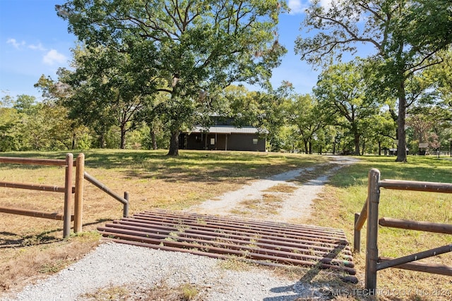 view of gate featuring a yard