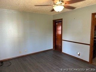 spare room featuring ceiling fan, dark hardwood / wood-style floors, and a textured ceiling