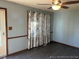 spare room featuring a textured ceiling, ceiling fan, and dark hardwood / wood-style flooring