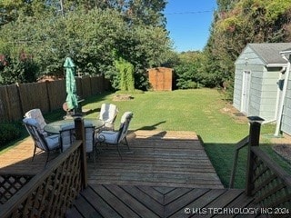 deck with a lawn and a storage unit