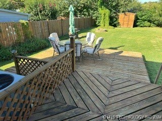 wooden deck featuring a yard