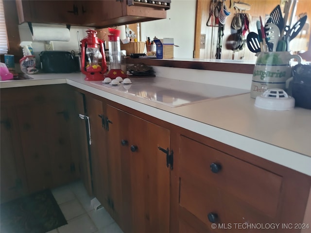 kitchen featuring white cooktop and light tile patterned floors