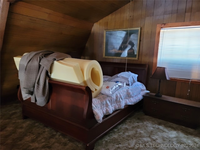 carpeted bedroom featuring lofted ceiling, wood walls, and wooden ceiling