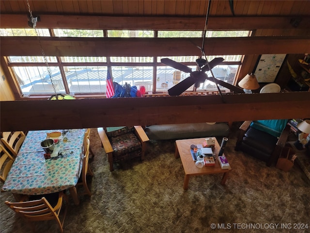 living room featuring wooden ceiling, carpet flooring, ceiling fan, and beamed ceiling