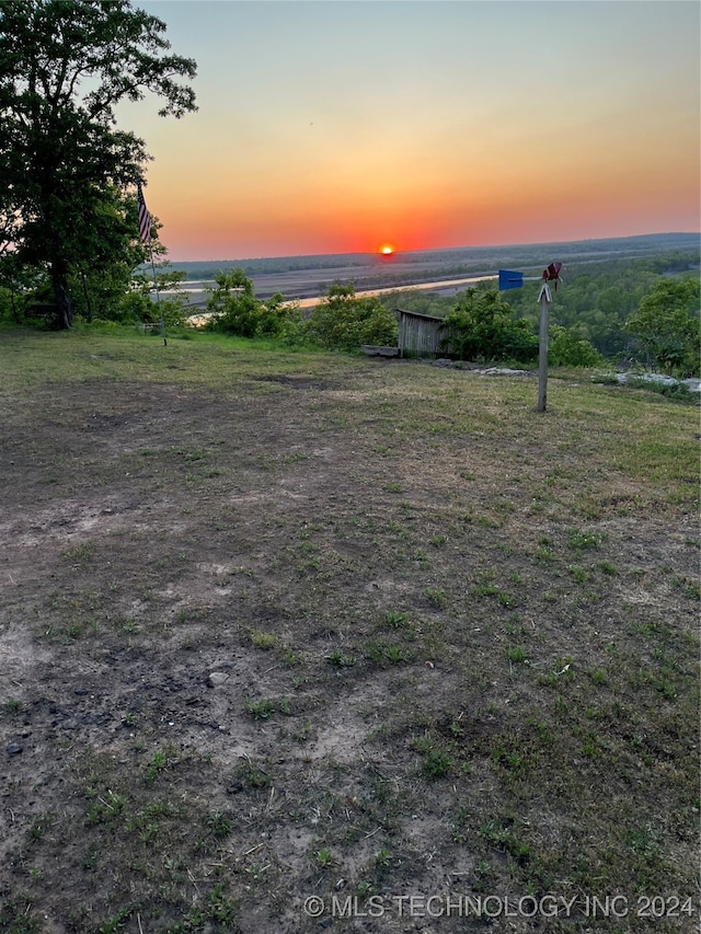 yard at dusk with a rural view