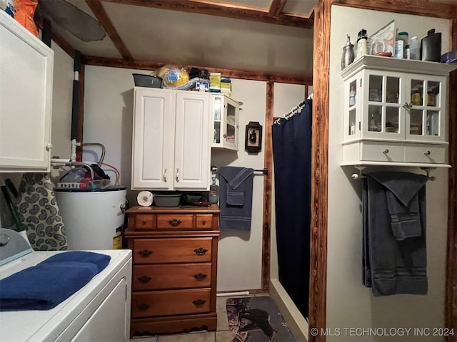 laundry room featuring gas water heater and washer / dryer