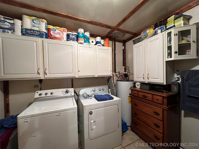 laundry room featuring light tile patterned floors, gas water heater, independent washer and dryer, and cabinets