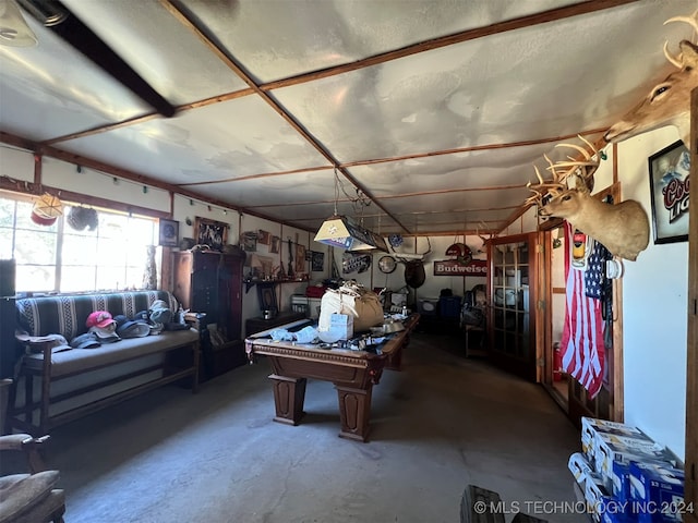 interior space featuring pool table and concrete flooring