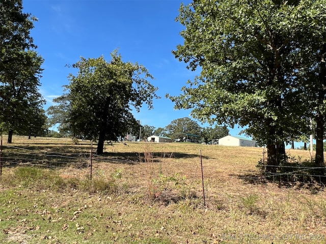 view of yard with a rural view